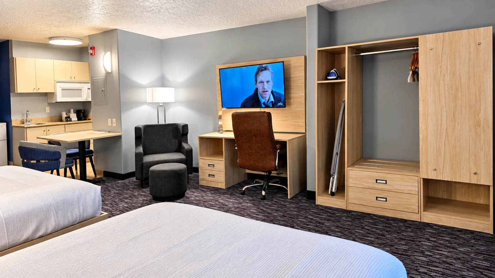 Kitchenette, dining table, seating area, desk and closet in a Studio Two Queen — Best Western Vernal Inn, Vernal Utah