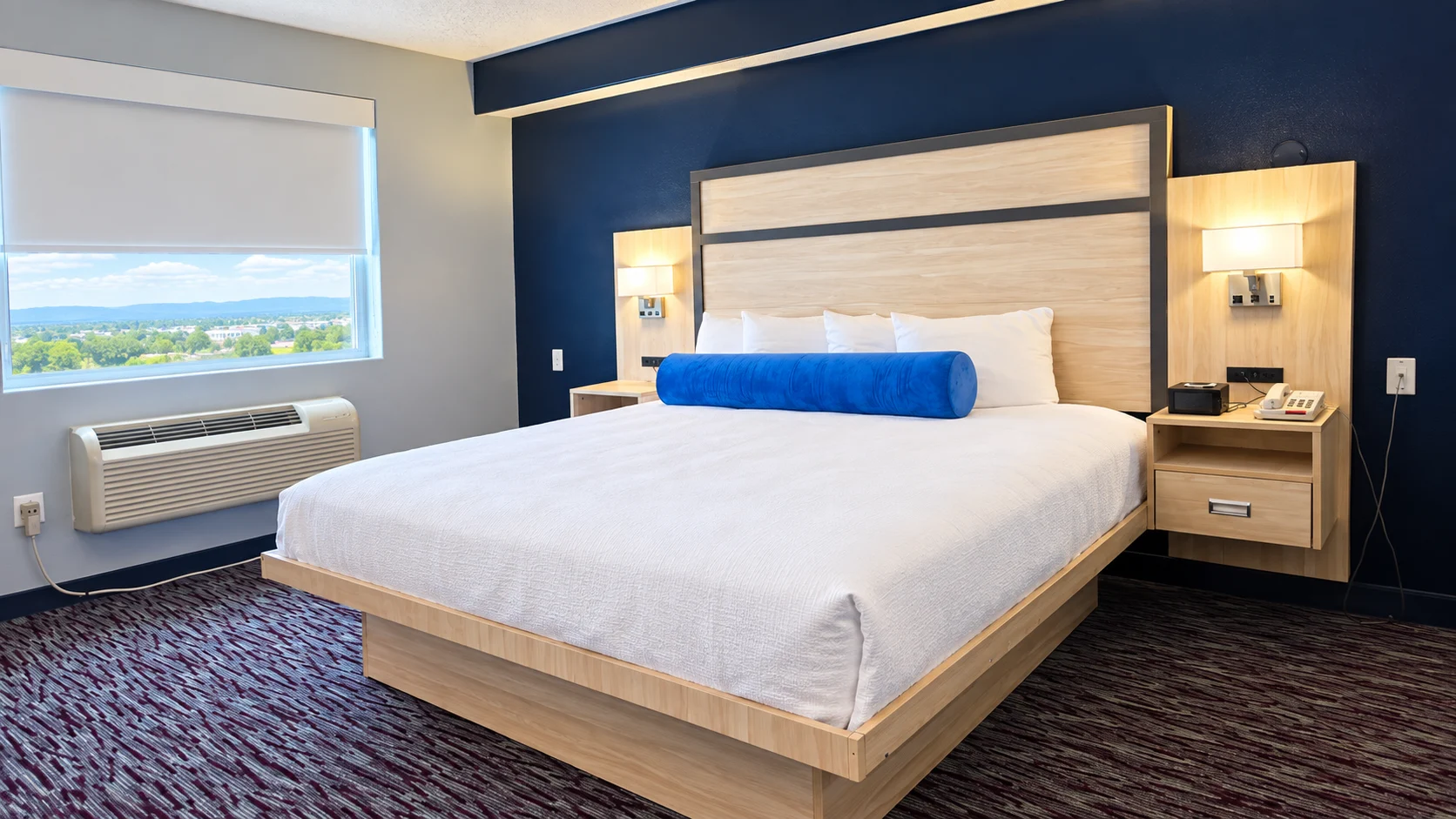 King bed beside a shaded window and heating and cooling unit — Best Western Vernal Inn, Vernal Utah