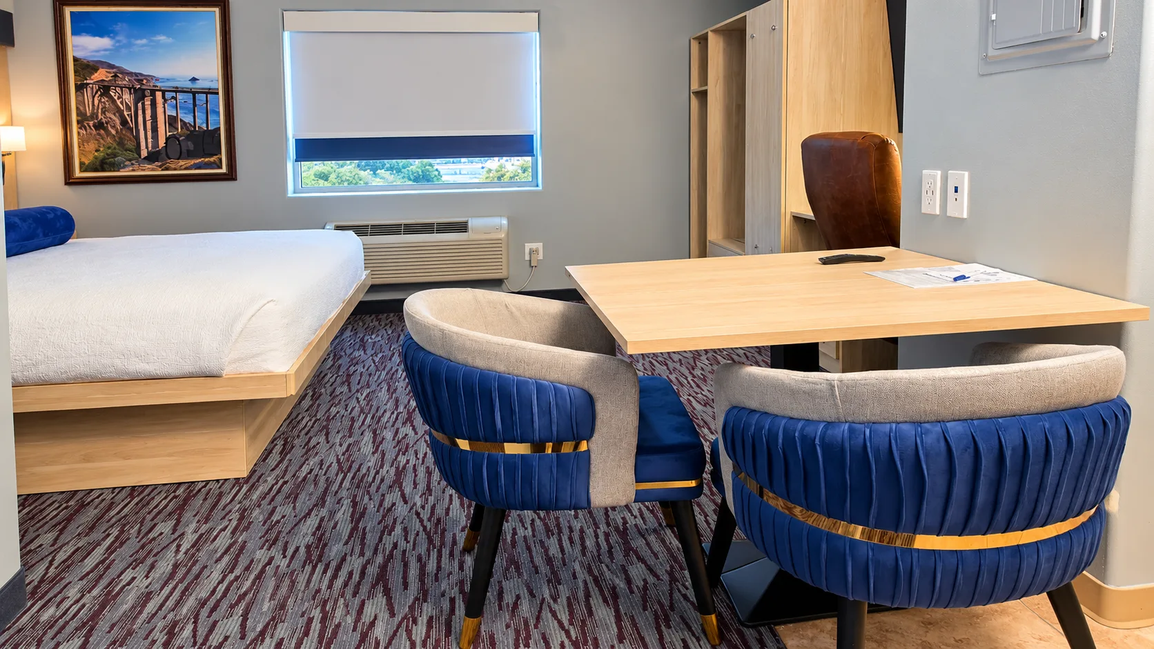 Dining table and two chairs beside a king bed and window — Best Western Vernal Inn, Vernal Utah