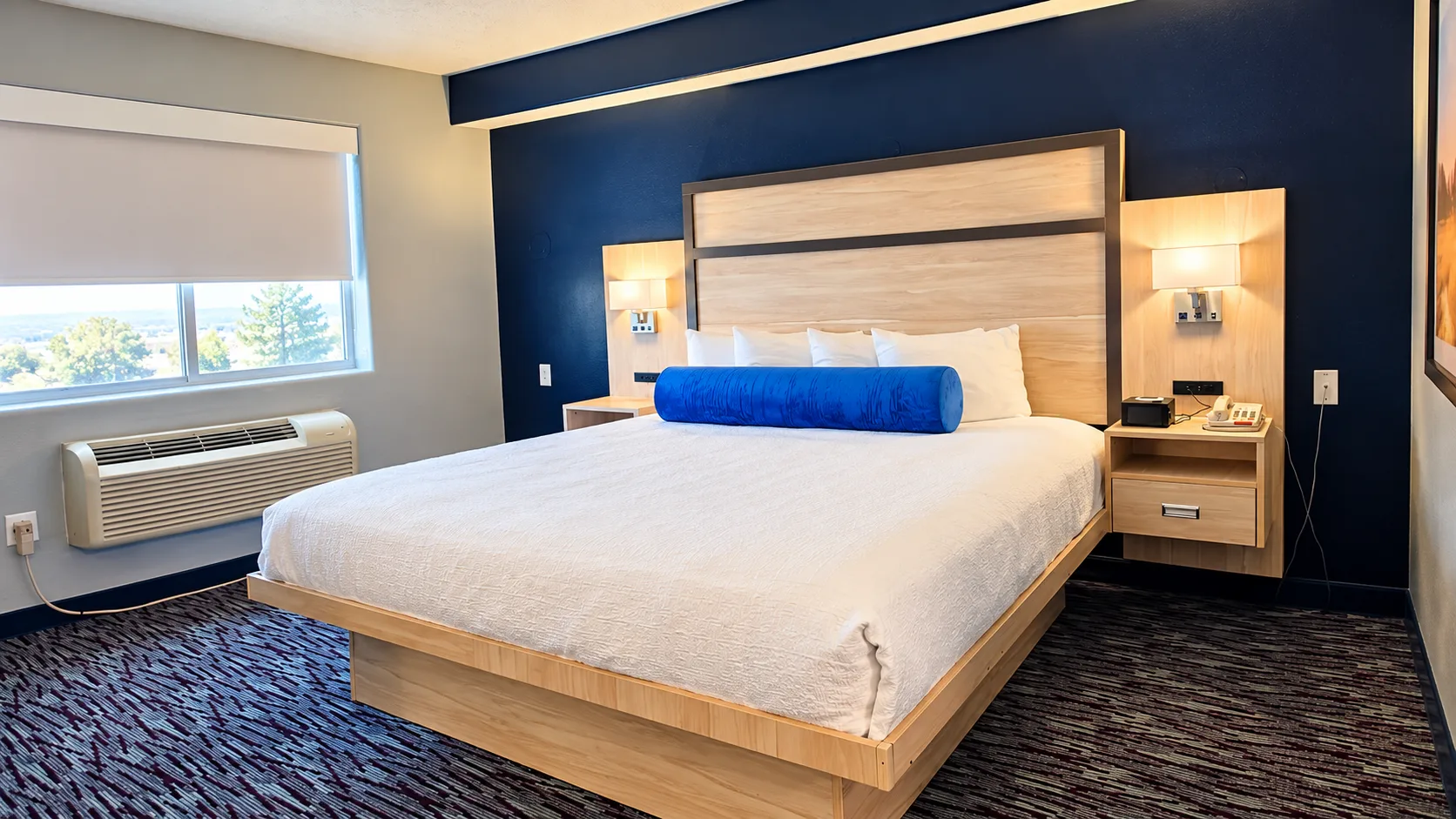 King bed beside a shaded window and heating and cooling unit — Best Western Vernal Inn, Vernal Utah