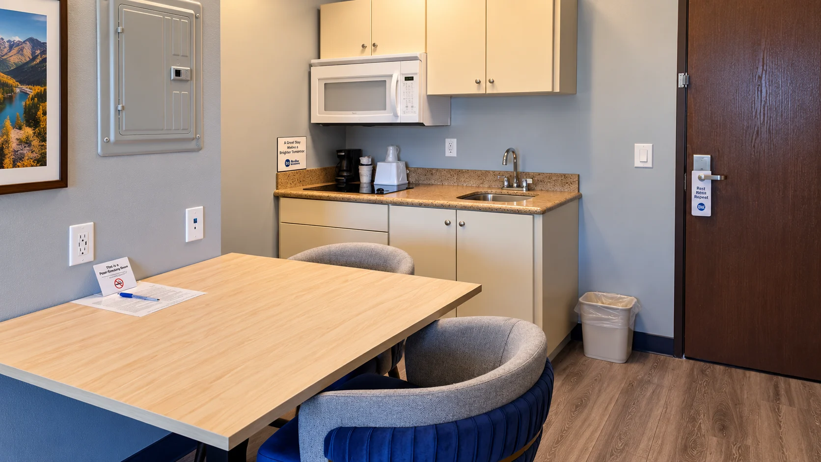 Kitchenette with sink, microwave and cabinets beside a dining table — Best Western Vernal Inn, Vernal Utah